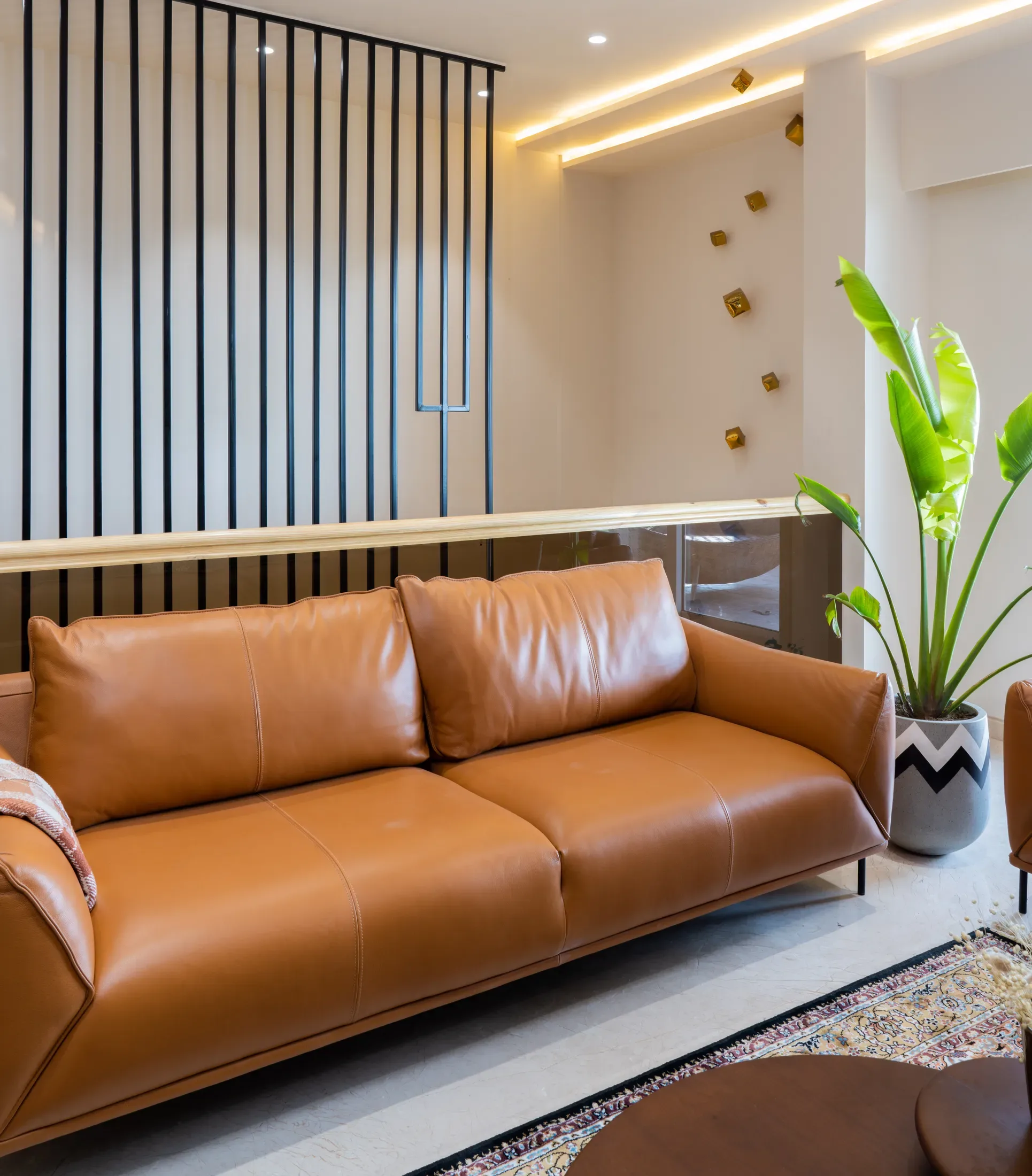 Living room with a leather sofa and full-height window
