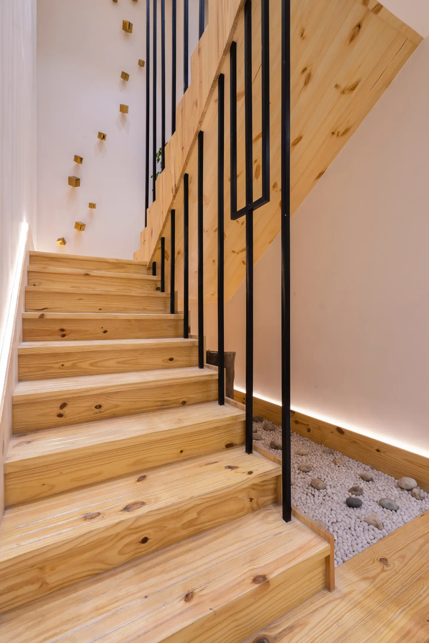 Sculpted stone staircase with a brass balustrade